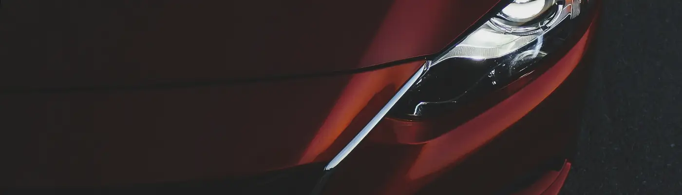 A red Lukoil racing car drifting on track with smoke effects showing dynamic motorsport action